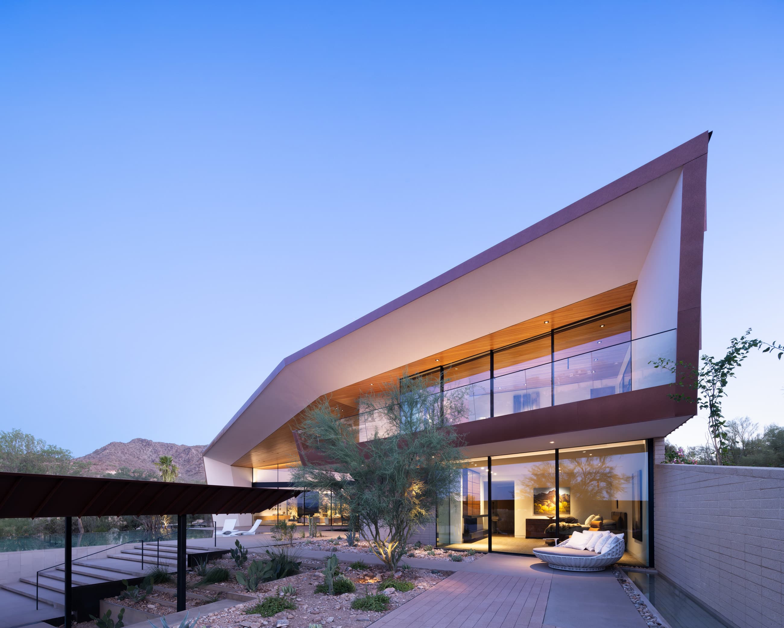 The Desert Geode residence at dusk, lit from within