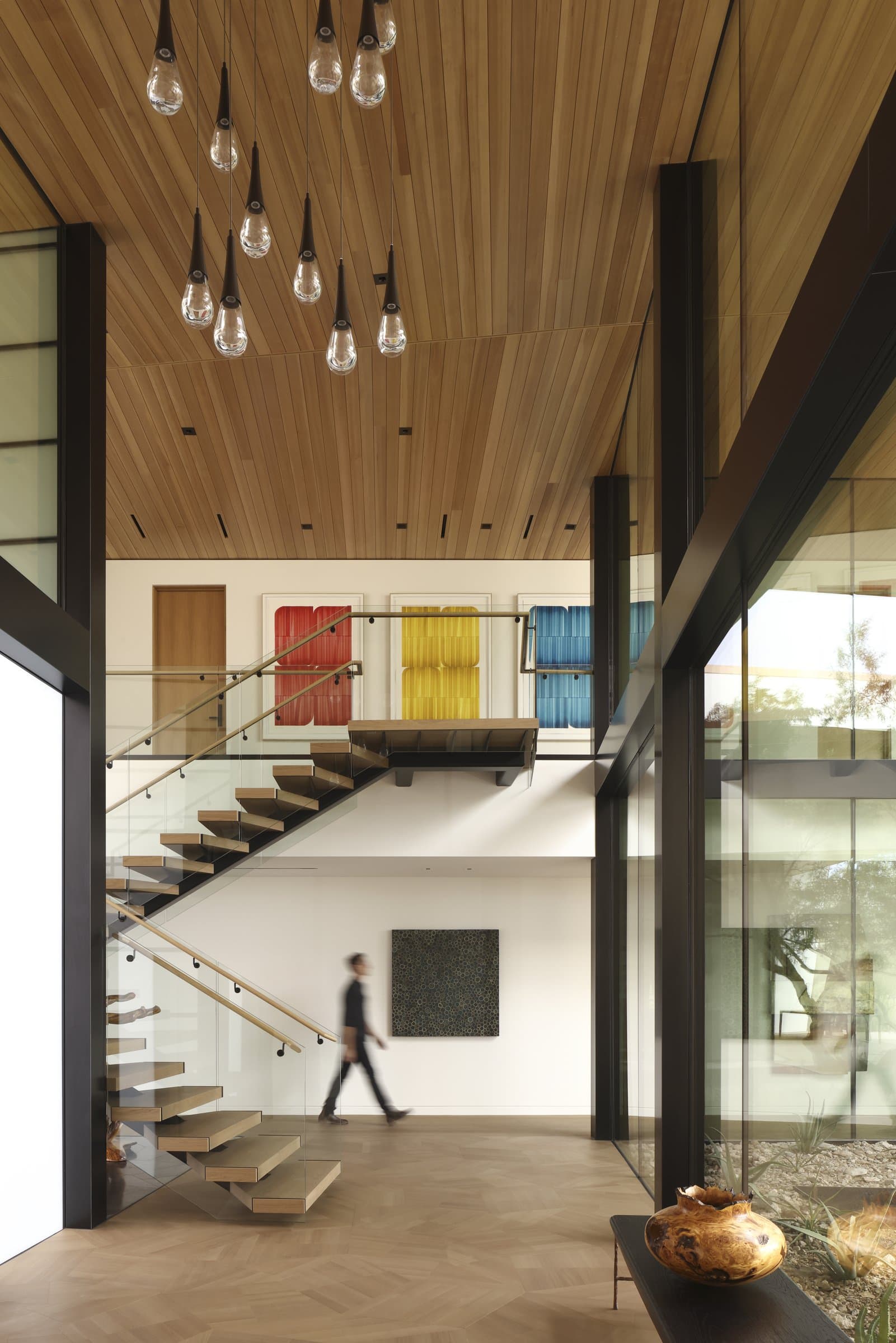 The stair hall under a cluster of pendants