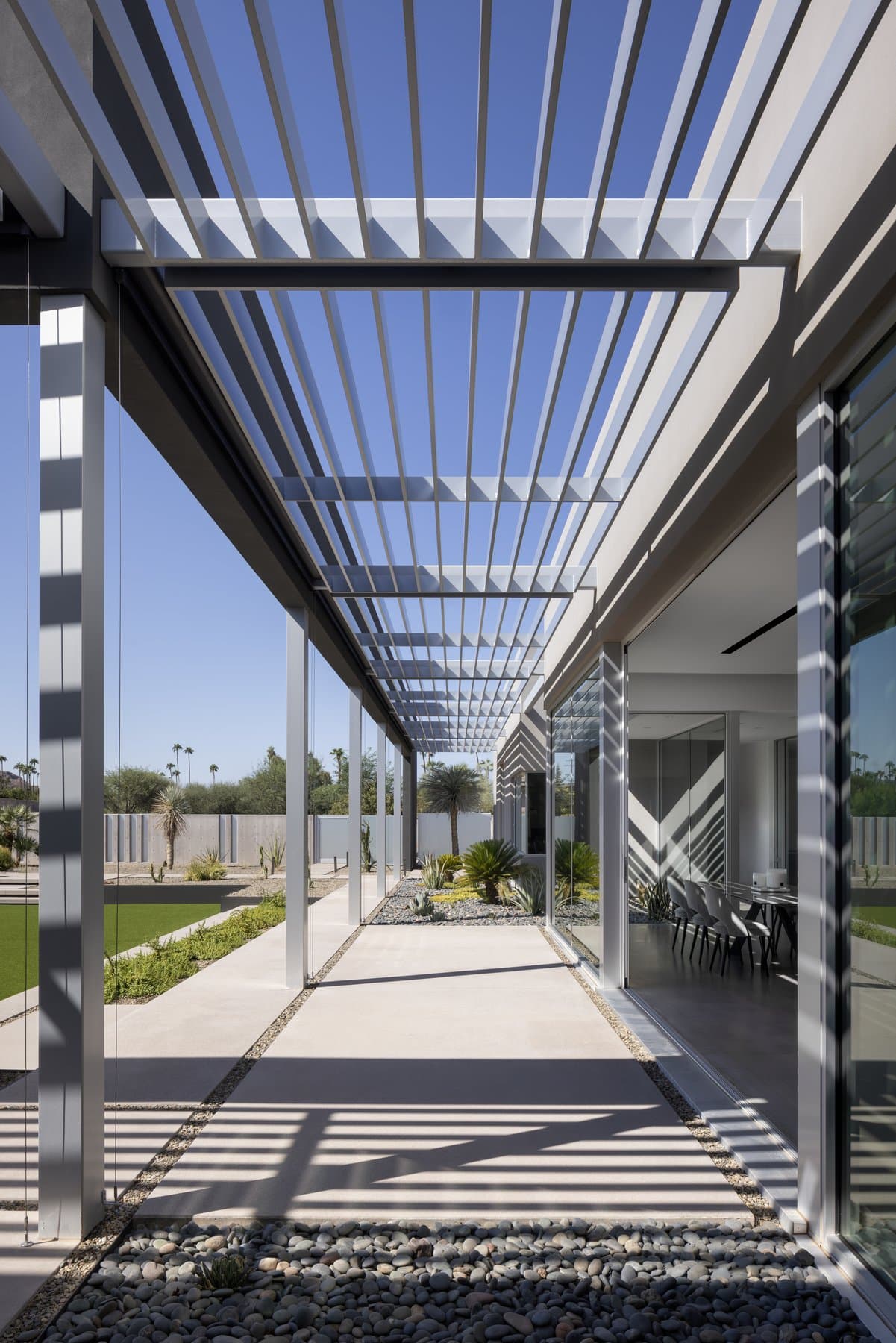 The louvered colonnade running the length of the house