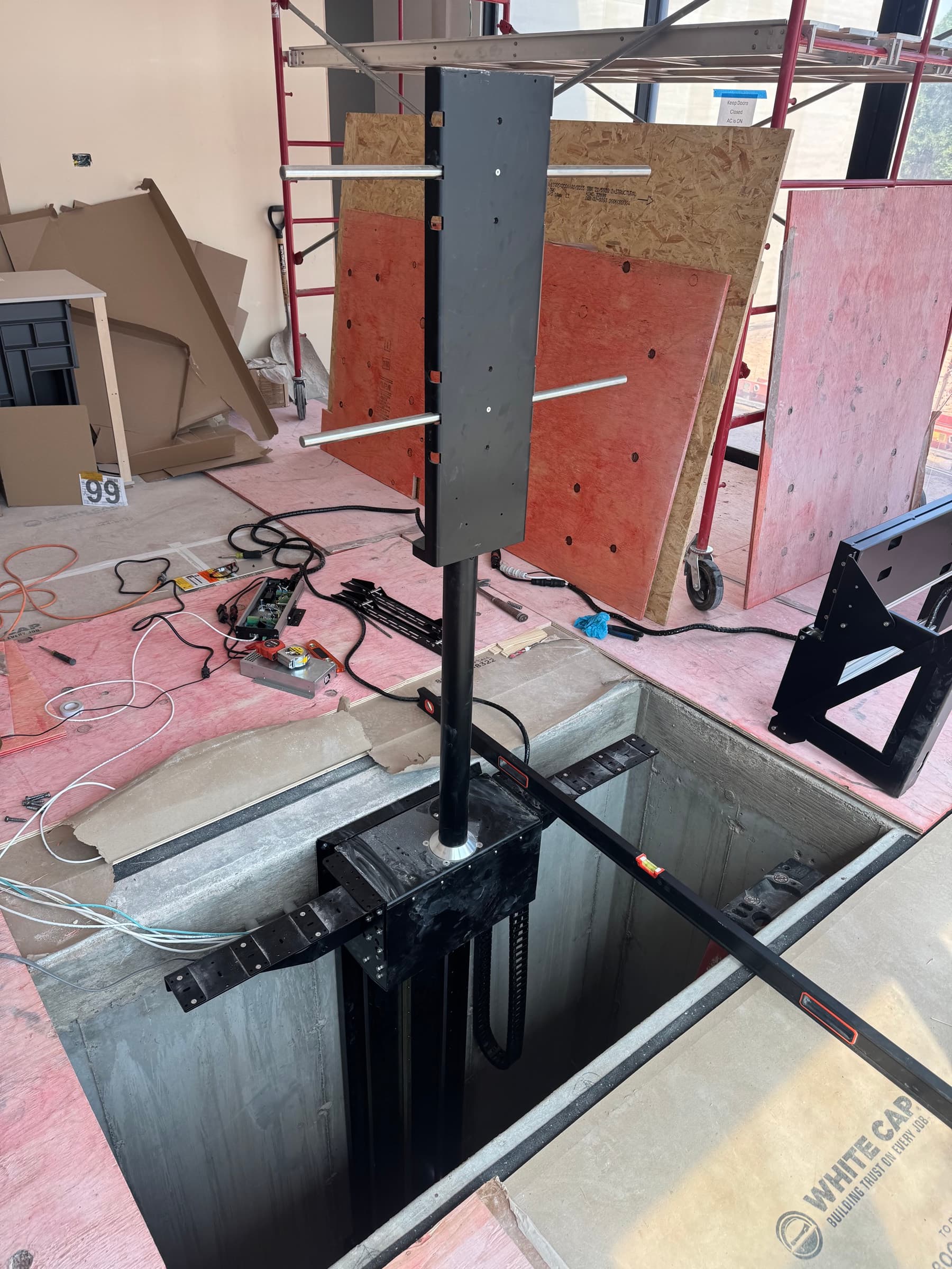 The television lift mechanism on the floor before installation