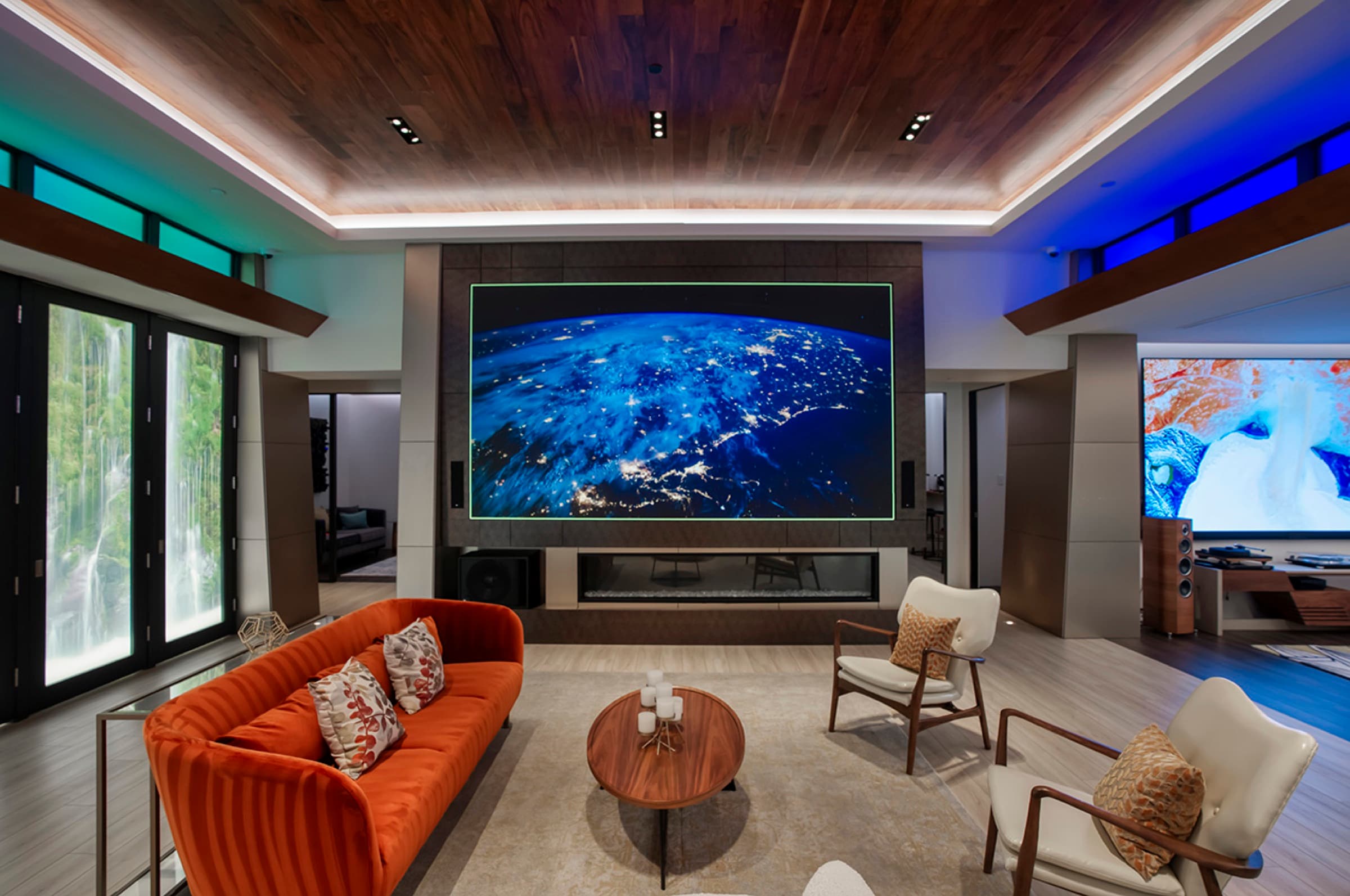 The showroom video wall showing the earth from orbit above the lounge