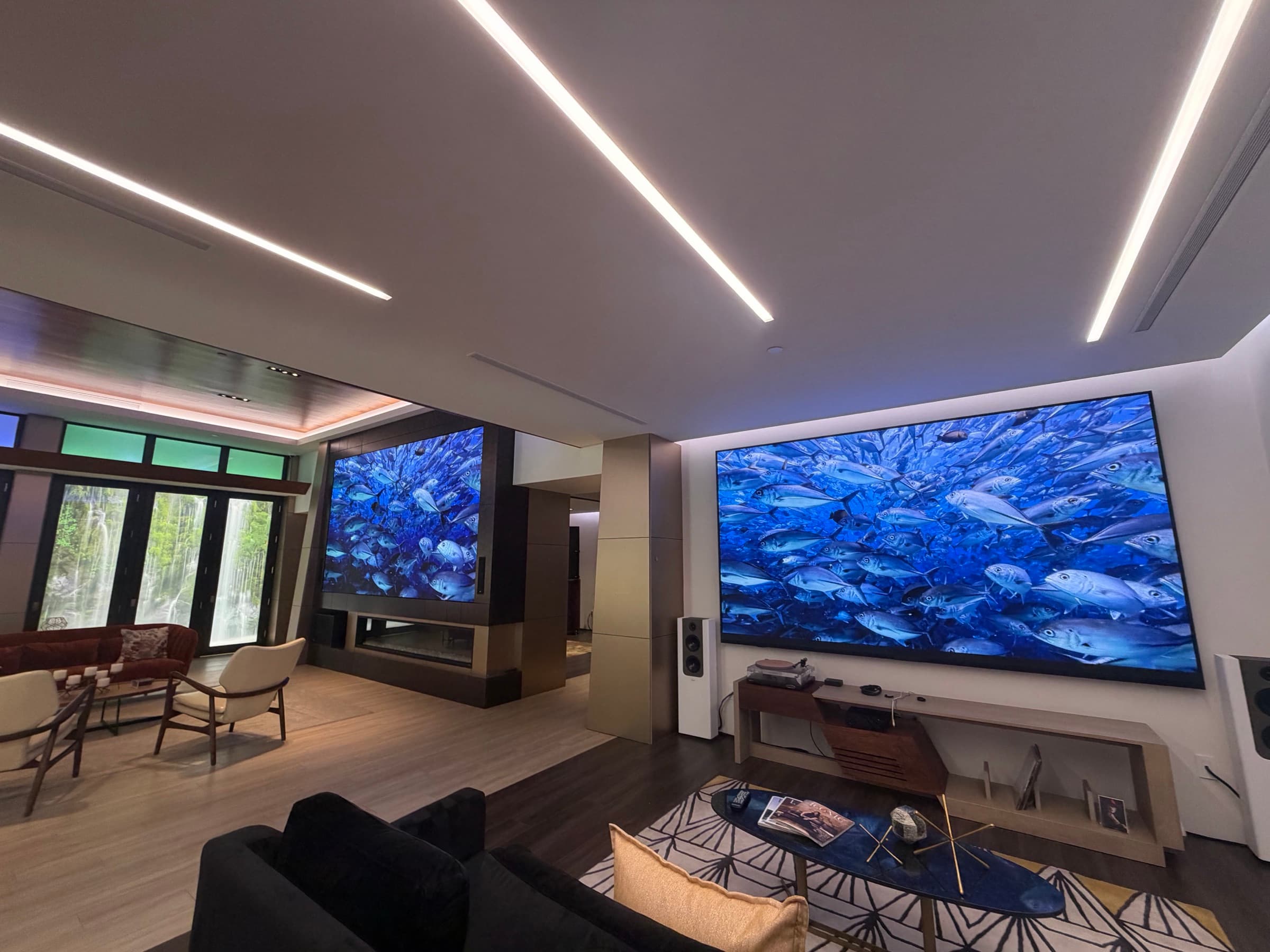 The video wall running an underwater scene beside the great room glass