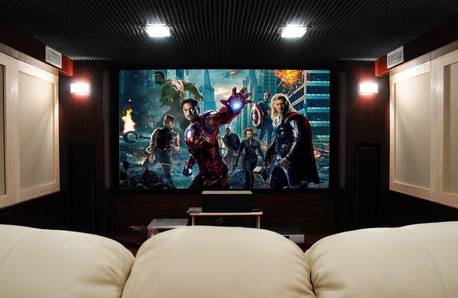 A luxurious home theater with comfy seats and a large screen.