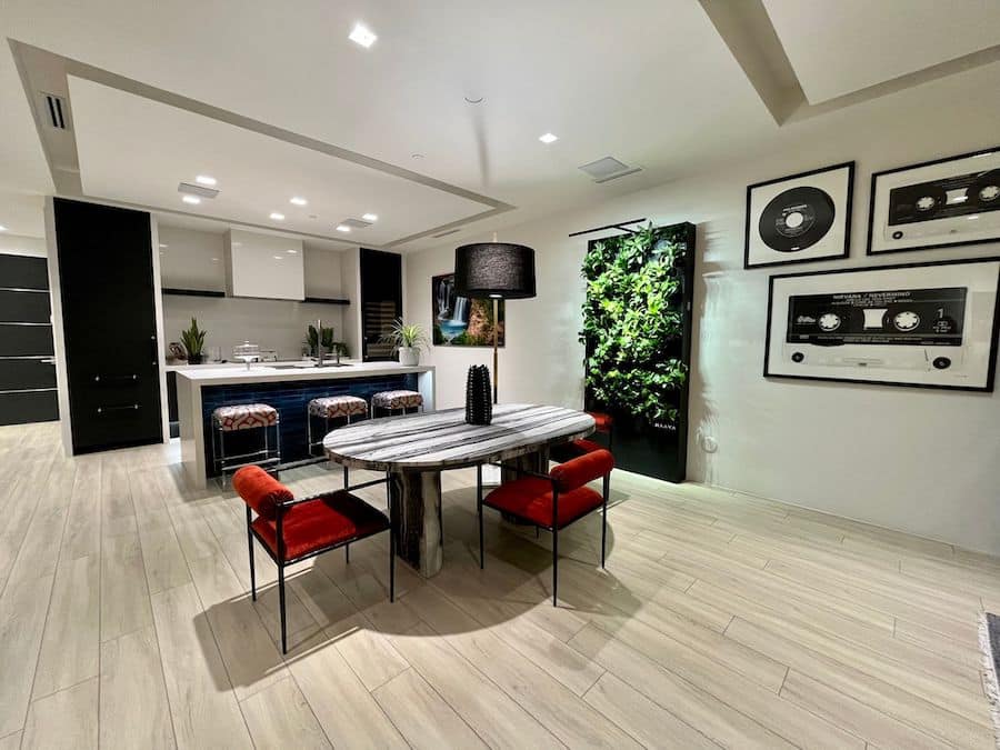 A kitchen and dining room with in-ceiling light fixtures.