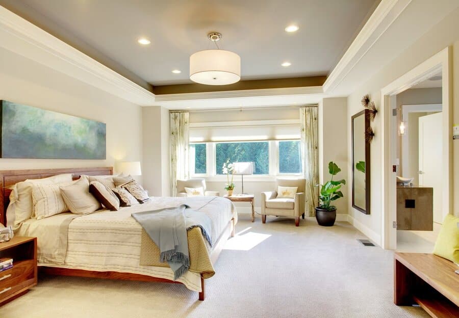 A bedroom featuring smart home automation solutions like in-ceiling smart lighting fixtures and motorized shades.