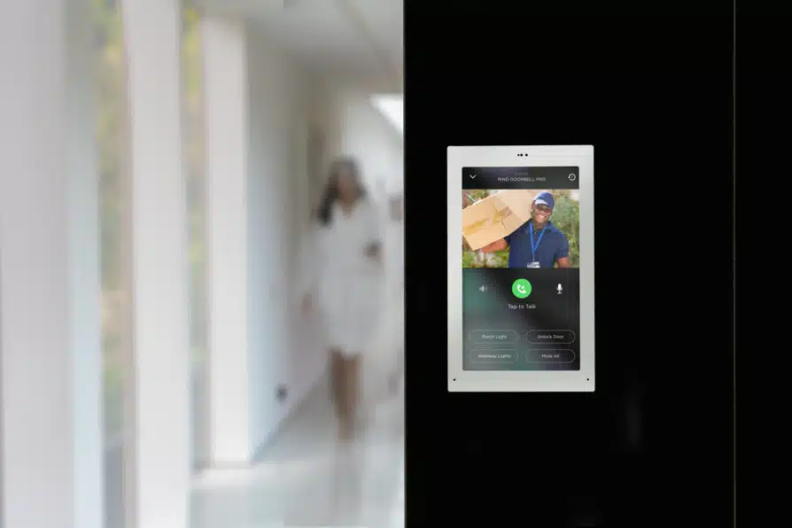 Video doorbell security camera footage showing live feed on a wall-mounted Savant tablet.